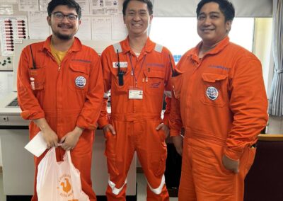 Seafarer Clients of Shore Leave Solutions LLC posing inside the ship, one holding Popeys takeout in cristi corpus