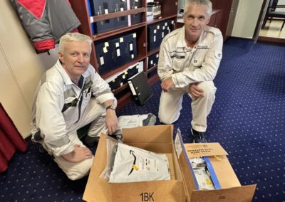 Seafarer Clients of Shore Leave Solutions LLC posing inside the ship each holding items bought by the company in cristi corpus